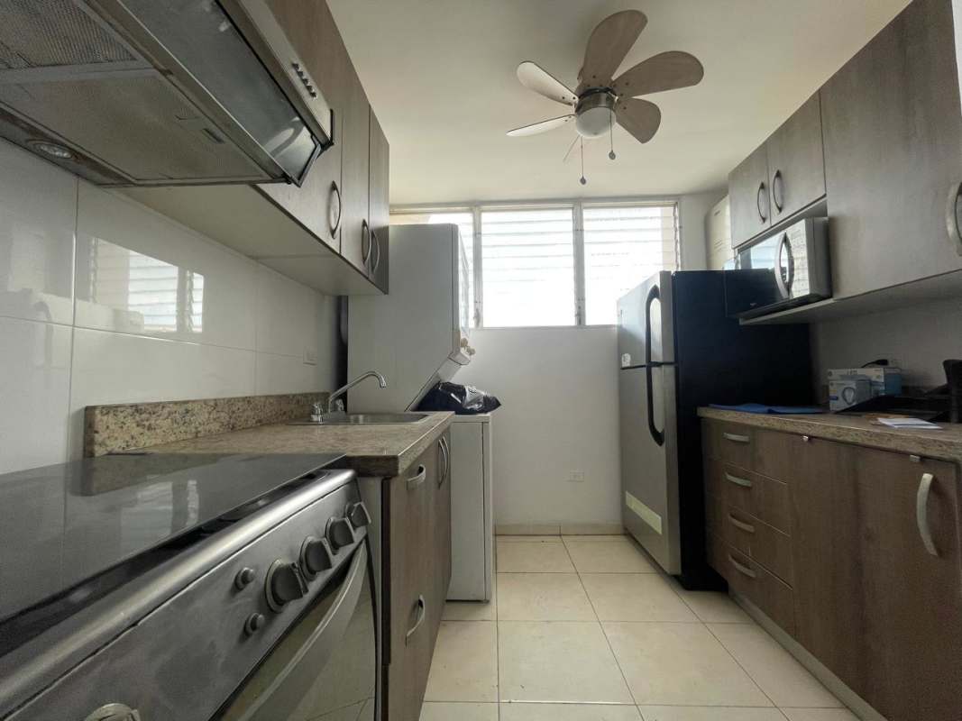 Compact modern kitchen with granite countertops stainless steel appliances and ceiling fan Panama rental