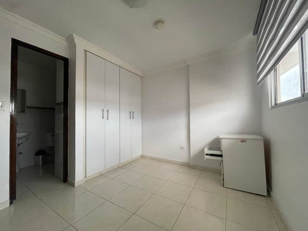 Compact kitchen with granite countertop, appliances and ceiling fan in Llano Bonito Panama rental apartment