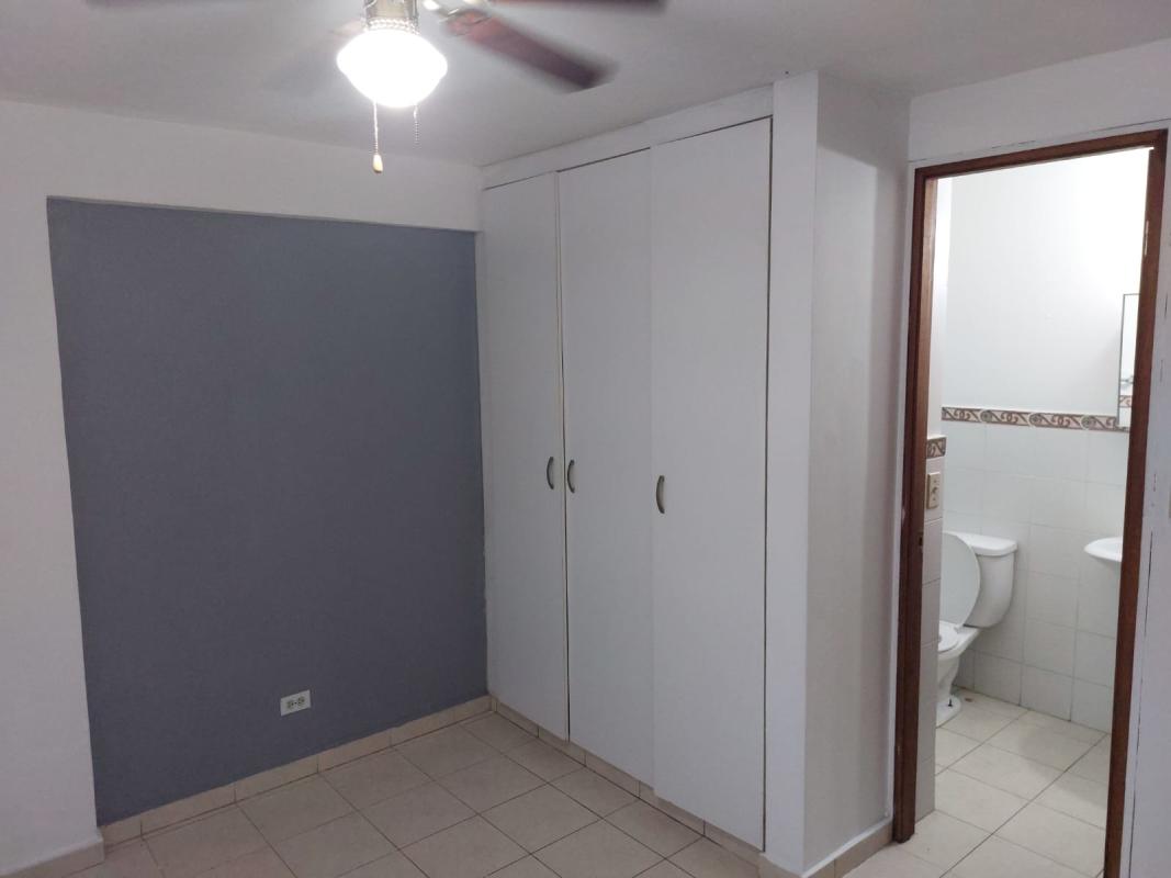 Bedroom with tile flooring, ceiling fan, and barred window for rent in Campo Limberg Panama