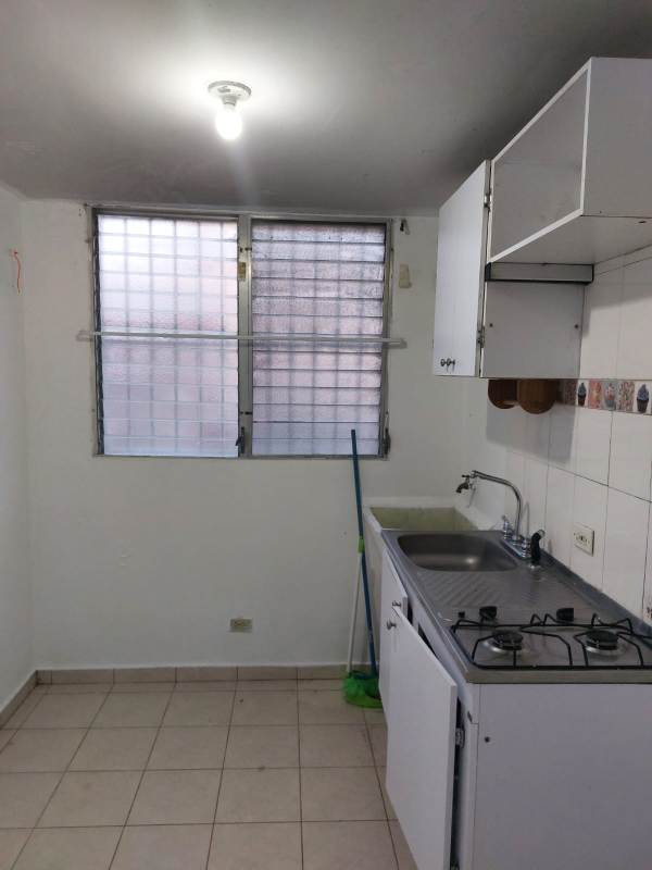 Bedroom with built-in closet, ceiling fan, and attached bathroom in Campo Limberg Panama apartment