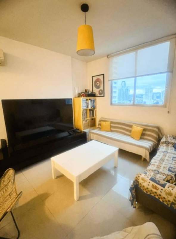 Apartment living space with glass door to balcony in PH Diamond Tower Panama