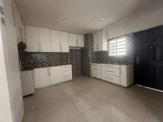 Large tiled living room with tray ceiling, natural light in house at Residencial Las Arboledas La Chorrera