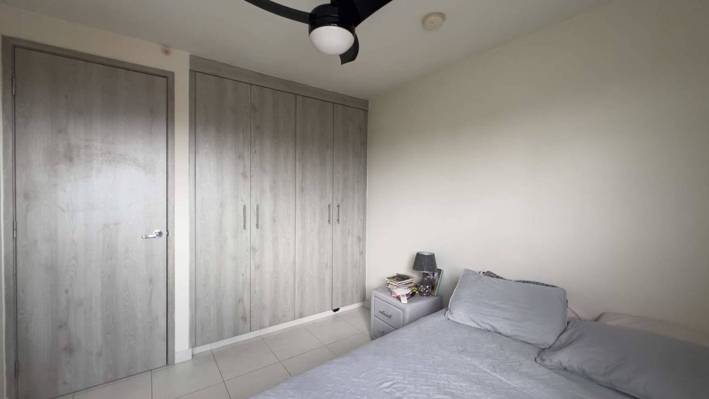 Bedroom with bed, large built-in closet, ceiling fan and air conditioning in Torres de Versalles Costa Sur Panama