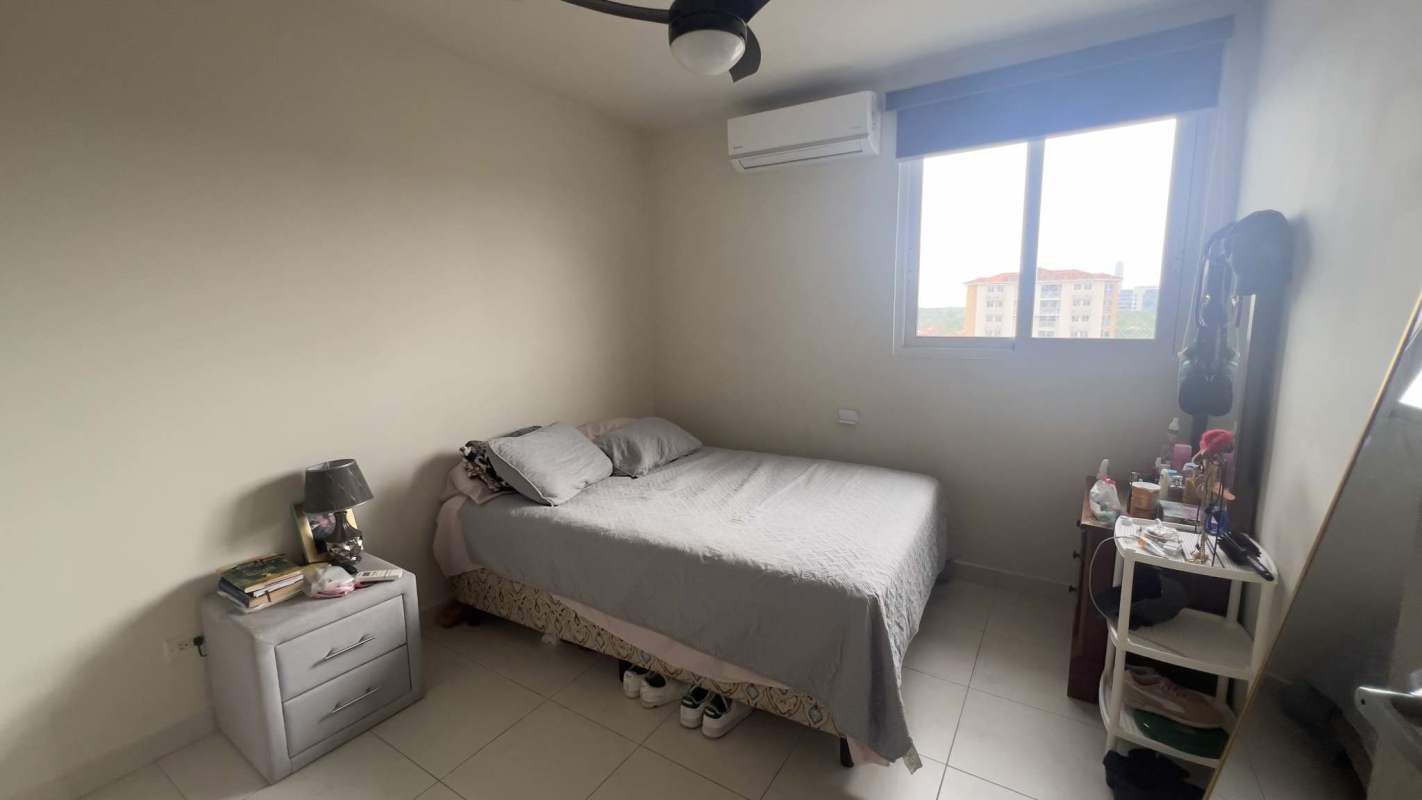 Minimalist bedroom with bed, AC, fan and window view in gated community Costa Sur Panama City