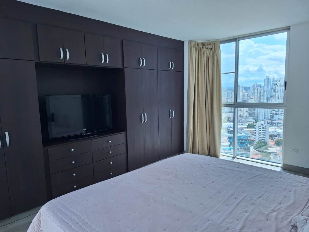 Modern open living and dining room with large windows city views in San Francisco Panama