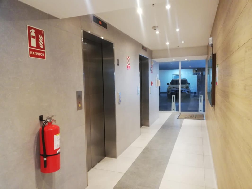Contemporary lobby with mirrored wall and designer furniture in Edison Park condo