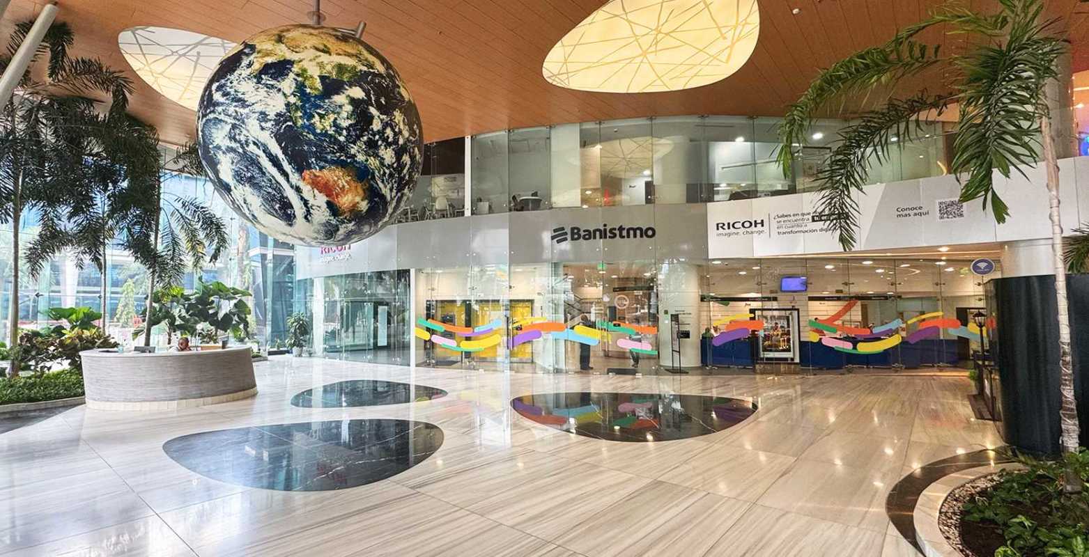 Interior view of furnished office cubicles with large windows overlooking Costa del Este