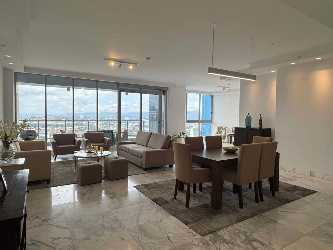 Luxury apartment open living dining area with floor-to-ceiling windows and ocean view in Costa del Este