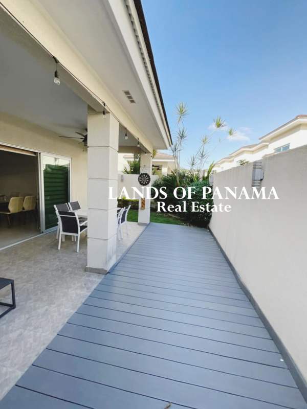 Outdoor pool with lounge chairs and green areas at Altos del Parque Residences Panama City