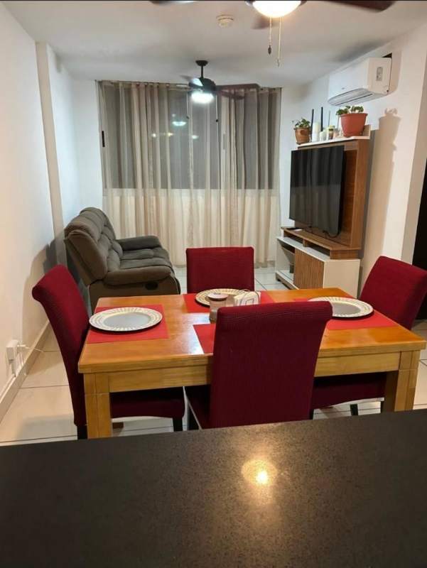 Outdoor pool with lounge chairs and playground at Mi Condado