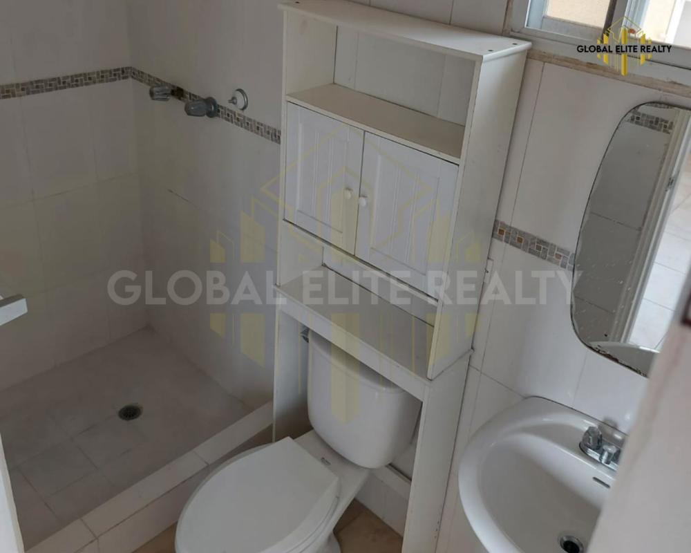 Bathroom with wall-mounted cabinet, tiled shower area in Villa Lucre Apartment Panama