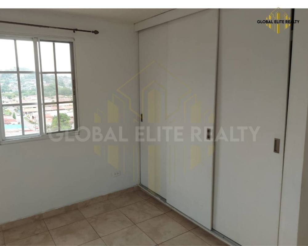 Bedroom with tile flooring, window view, and closet in Villa Lucre apartment Panama