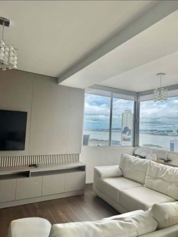 Modern living room with ocean-facing windows white sectional sofa PH Plaza Paitilla Panama