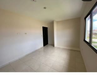 Bedroom with large window tiled floor black door Residencial Piamonte David Panama