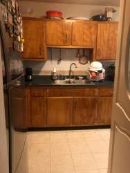 Kitchen with wooden cabinets and granite countertops in Residencial José Dominador Bazán Colon Panama