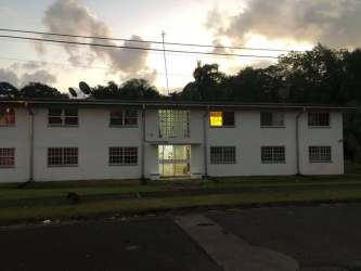 Two-story white apartment building Residencial José Dominador Bazán Fort Davis Colon Panama