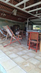 Outdoor bohio with dining area and bar at Costa Esmeralda beach home Panama