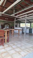 Indoor rustic kitchen with wood finish and dining space at San Carlos property