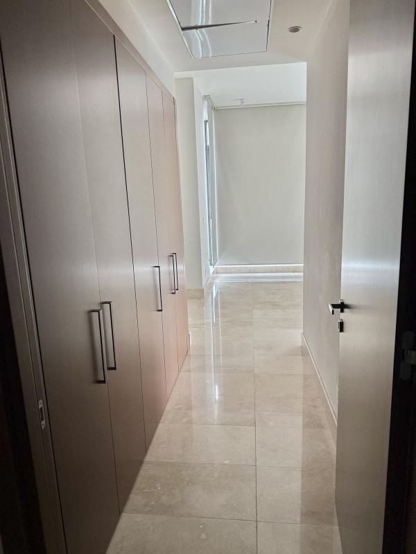 Bright hallway with marble tiles and built-in wardrobes at PH Mansion One Santa María Panama