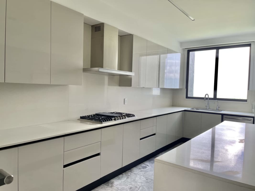 Open-concept living dining room with floor-to-ceiling windows in Santa María apartment Panama City