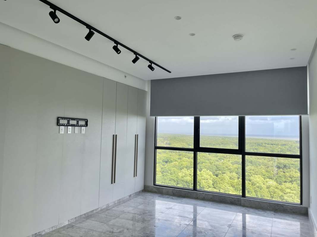 Empty bedroom with city and ocean views, marble floors in Ocean House Santa María Panama