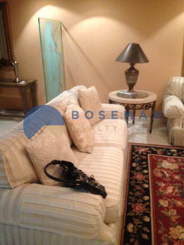 Elegant living room with striped sofa, ornate table and wall mirror in PH La Fontana Obarrio Panama City