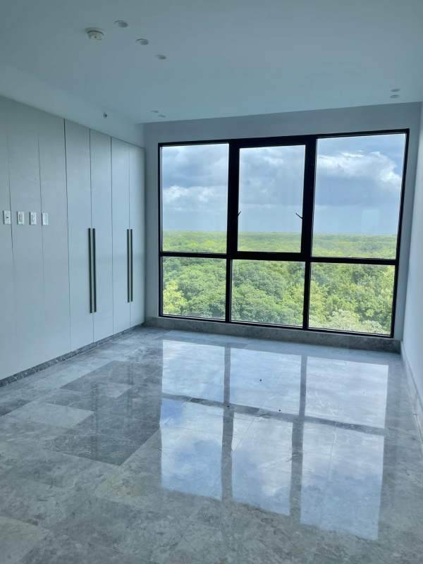 Spacious minimalist walk-in closet with built-in shelves and drawers at PH Oceana Residences Santa María Panama City