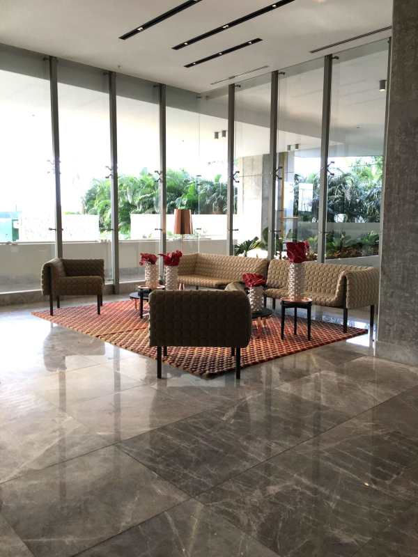 Elegant lobby with marble floors, glass walls, modern furniture in PH Oceana Golf Panama