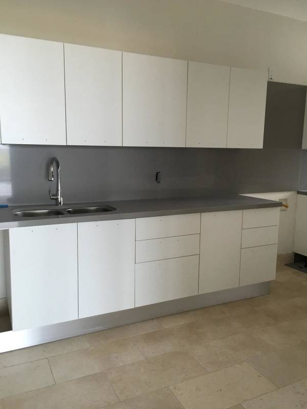Kitchen with white cabinets, granite countertops, double stainless steel sink in PH Oceana Golf Panama City