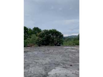 Vacant fenced industrial lot along Pan-American Highway with access road