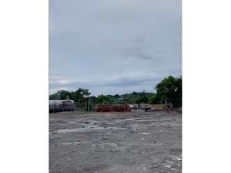 Fenced commercial lot with flat terrain ideal for warehouse or industrial use