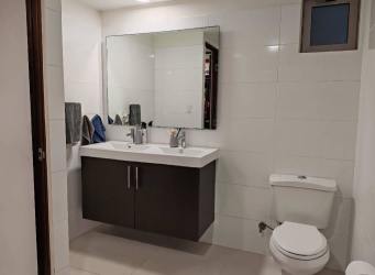 Swimming pool surrounded by tropical gardens at PH Midrise Panama Pacifico