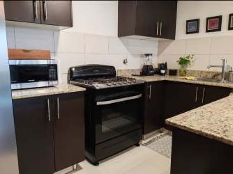 Secondary bedroom with built-in closet and tile floors in PH Midrise Panama Pacifico