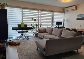 Spacious living room with tile floors, wide windows, and balcony access in PH Midrise Panama Pacifico