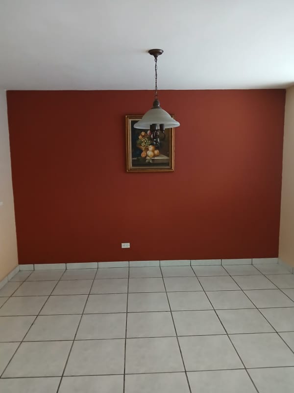 Dining area with red accent wall white floor tiles and lighting fixture Condado del Rey Panama house