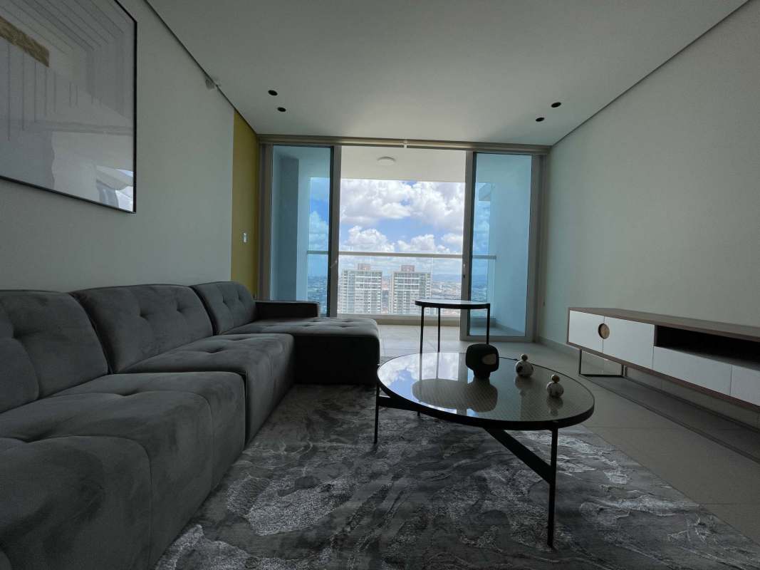 Spacious living dining room with panoramic windows overlooking Costa del Este in PH Country Club Panama City