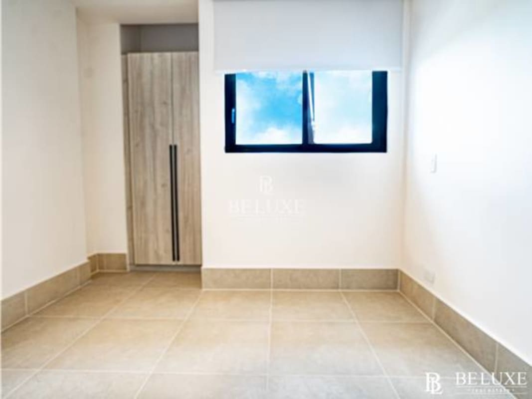 Bright bedroom with large window and ceramic flooring at PH Ocean House Panama