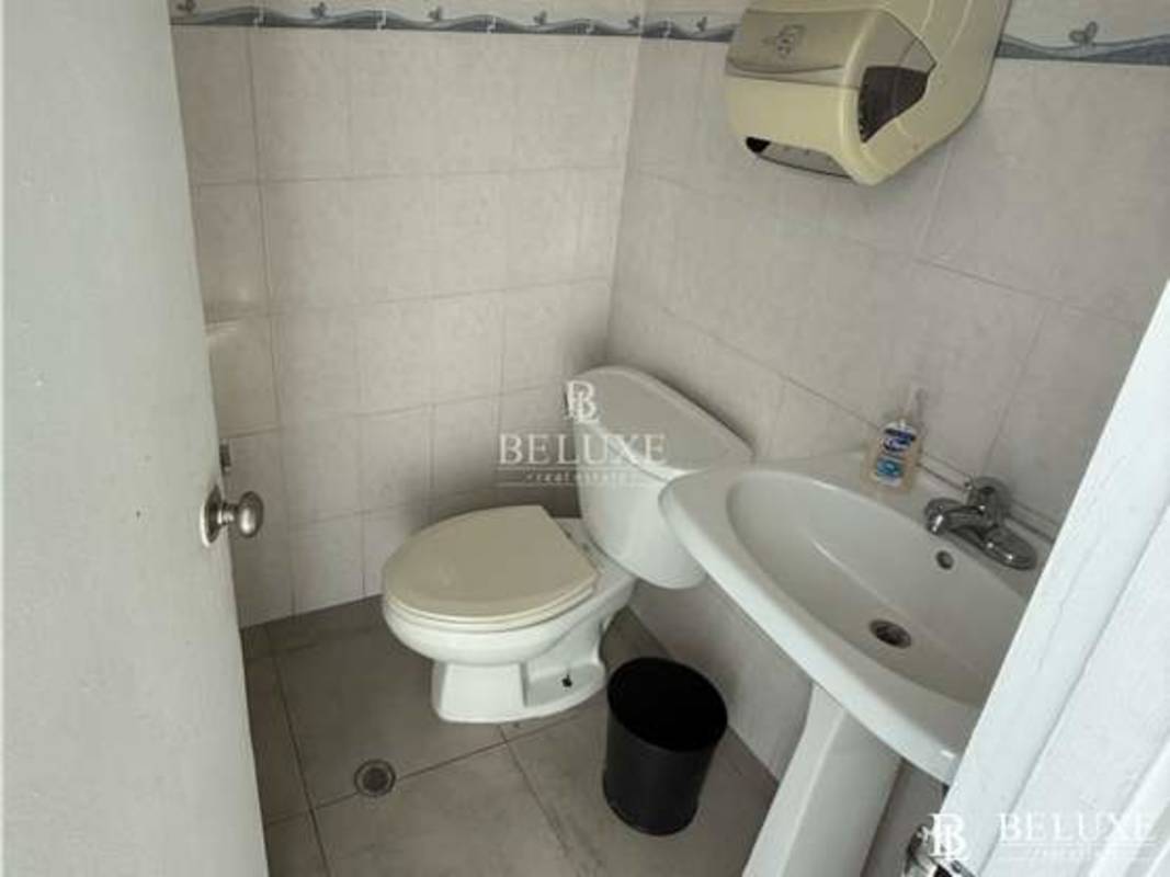 Compact kitchenette with cabinets, microwave space, countertops in commercial office Panama