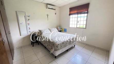 Contemporary bathroom with glass shower, tiled walls, sink and toilet La Fontana David Panama