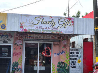 Exterior flower gift retail shop with glass doors colorful signage on busy street La Chorrera Panama