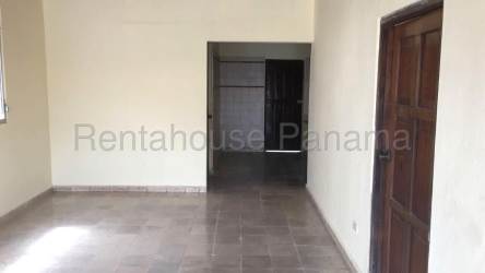 Empty living room with tiled floor beige walls wooden door open doorway La Chorrera Panama