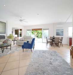 Bright open living-dining area with ceiling fans and natural light in Boquete condo for rent