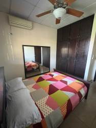 Modern bathroom with glass shower and pedestal sink in furnished home David Chiriquí
