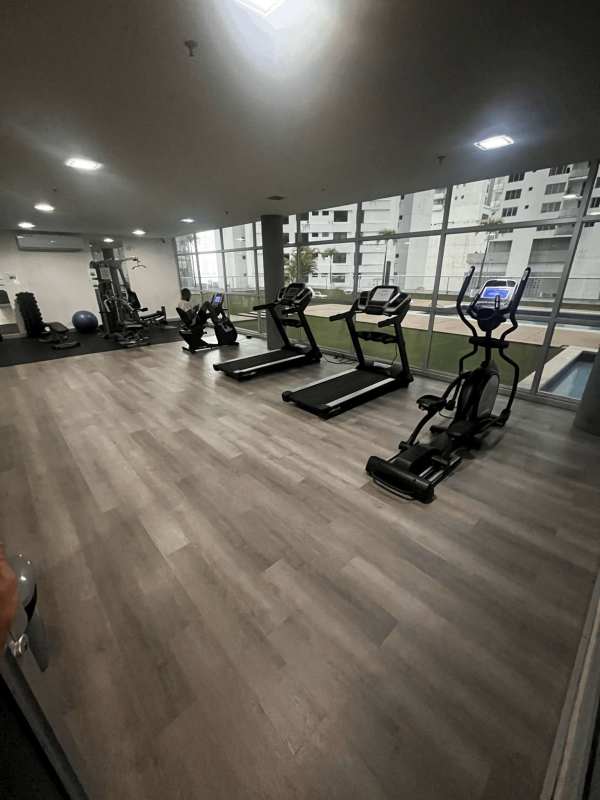 Modern studio apartment with floor-to-ceiling windows featuring ocean and skyline views at PH Colores de Bella Vista Panama