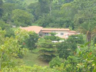 Covered barbecue area and pool next to single-story ranch house Los Díaz Santa Rita Panama