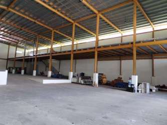 Wide industrial warehouse with exposed beams mezzanine level on Pan-American Highway Panama