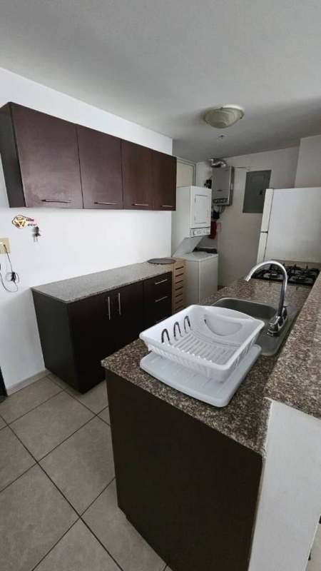 Spacious living and dining with furniture, bright windows at PH Torre Alsacia