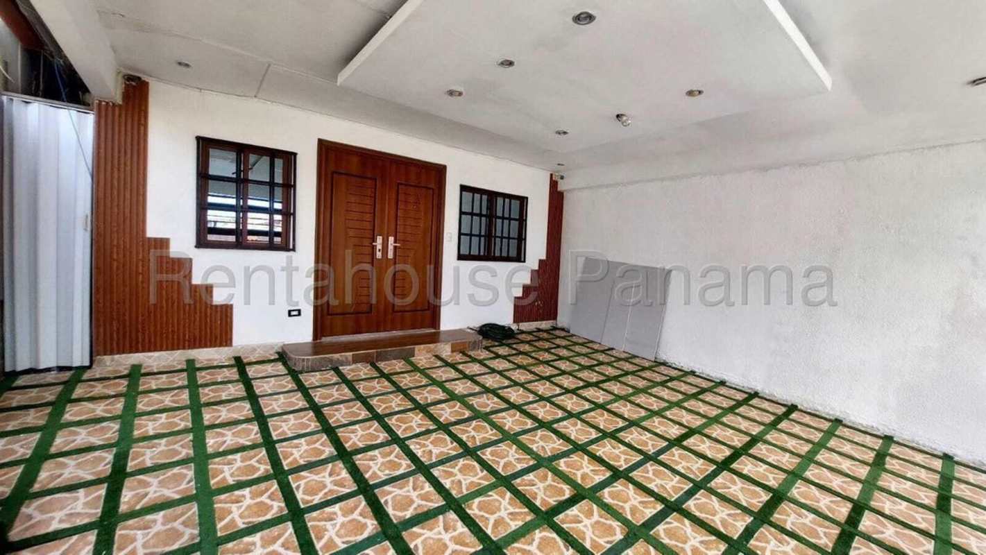 Covered entrance with wood doors, tile floor, decorative planter Condado del Rey Panama