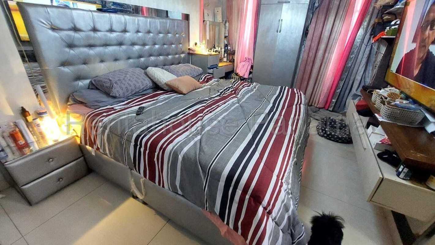 Bedroom with striped bedding, vanity, tufted headboard and wardrobe Condado del Rey Panama