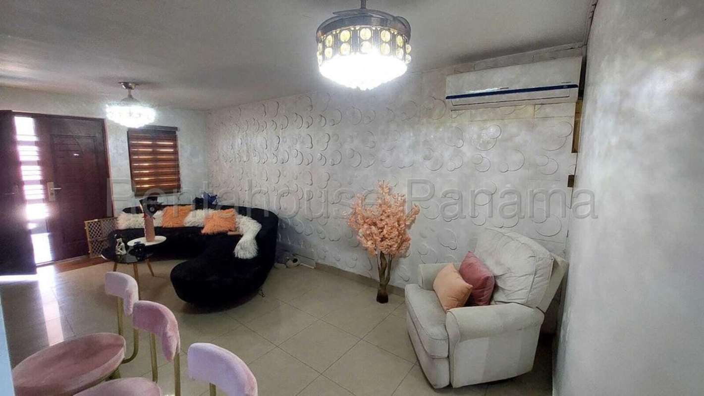 Bright furnished living room with black sofa and textured wall, Condado del Rey Panama City